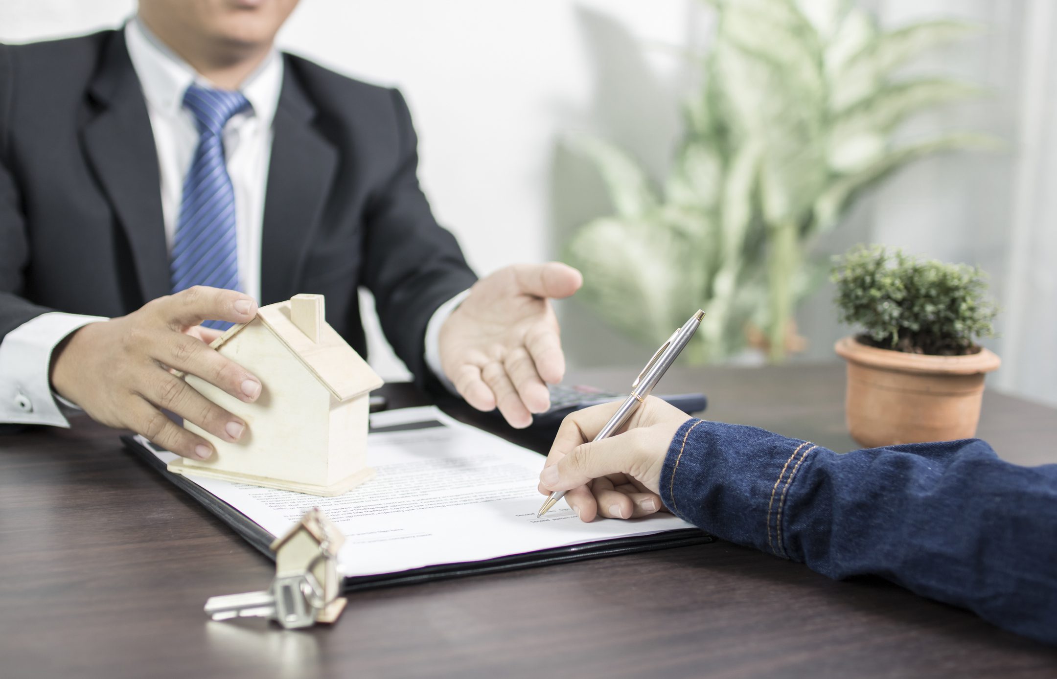 Mortgage lender discusses paperwork with a client for generate-mortgage-leads blog.