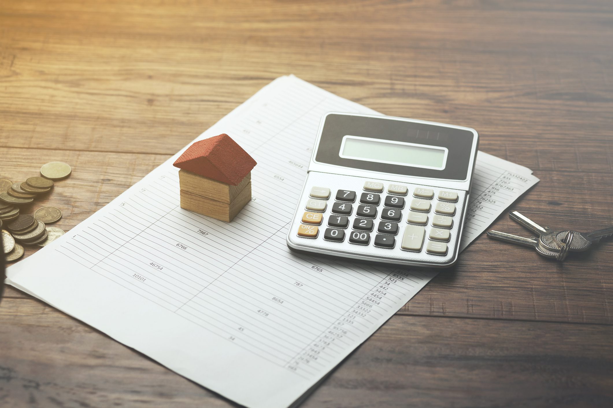 A house model, calculator, and key near a loan document for cheap-internet-leads blog.